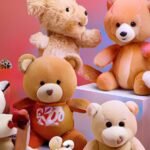 A collection of colorful stuffed animals from SKZOO arranged neatly on a table, showcasing Stray Kids' charming mascots.